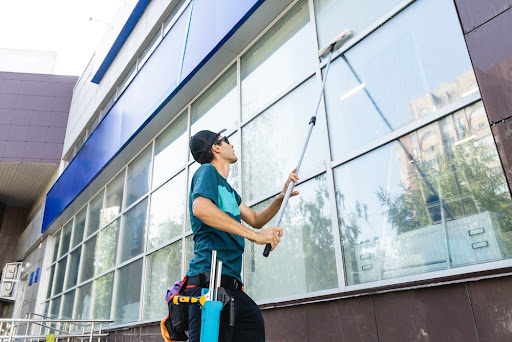 cleaning professional washing exterior window of commercial business building