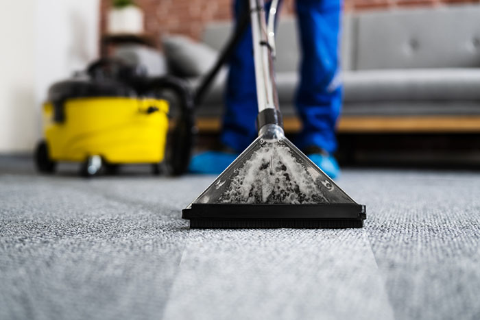 professional deep cleaning an office carpet in a commercial business space