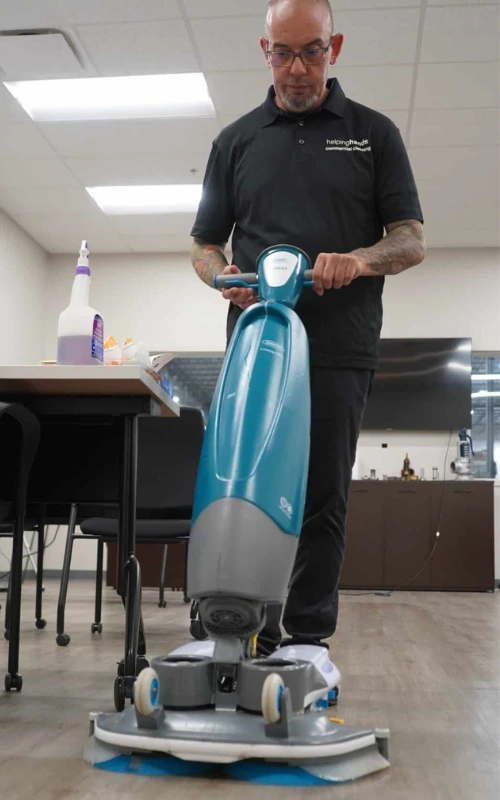 commercial cleaning professional man deep cleaning floor in facility, office