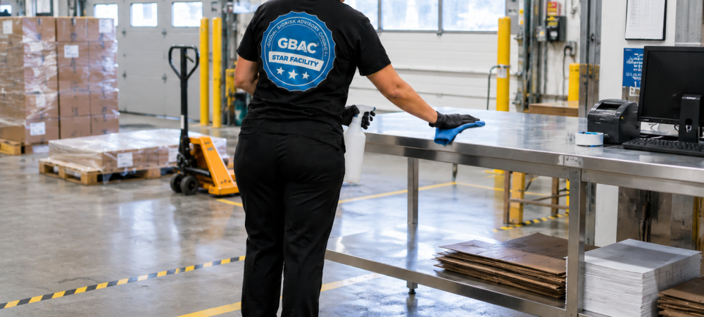 Facility manager reviewing industrial cleaning vendor documentation and inspection reports before signing a janitorial contract in a Chicagoland manufacturing facility